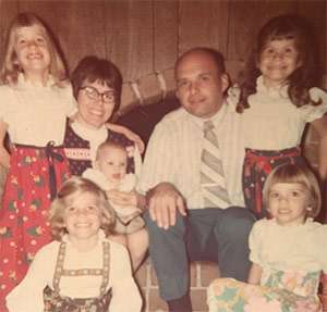 “The 5 Hallerettes” as children smiling for the camera with their parents in 1973.
