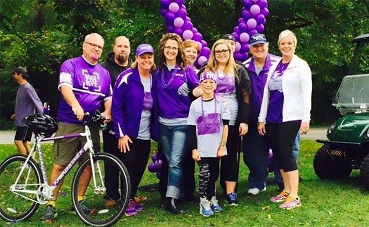 Lisa Beckendorf, a pancreatic cancer survivor and volunteer, at right with friends at PurpleRideStride bike ride and 5K walk.