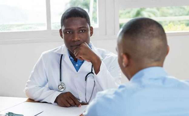 An African-American doctor and patient discuss pancreatic cancer statistics