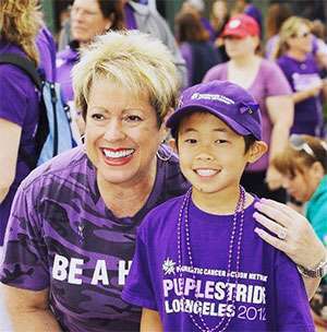 Young boy smiles with PanCAN founder at 5k walk to end pancreatic cancer in Los Angeles