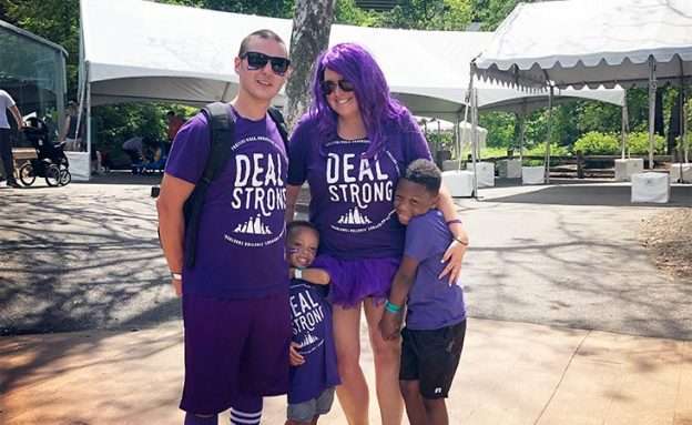 Young pancreatic cancer survivor participates in fundraising walk with his wife and two sons