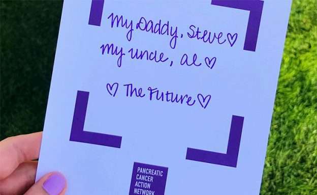 A sign tells why this PanCAN advocate is involved