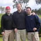 Dad and two adult sons golfing